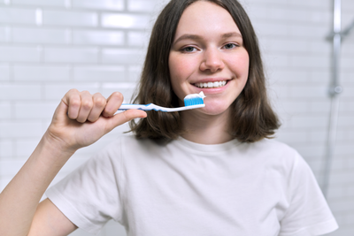 Woman using toothpaste