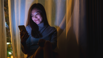 Woman with her phone in full brightness