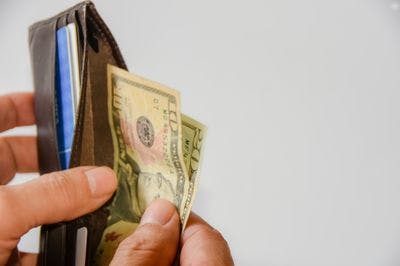 Man taking cash out of wallet