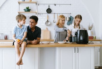 Happy family cooking with air fryer